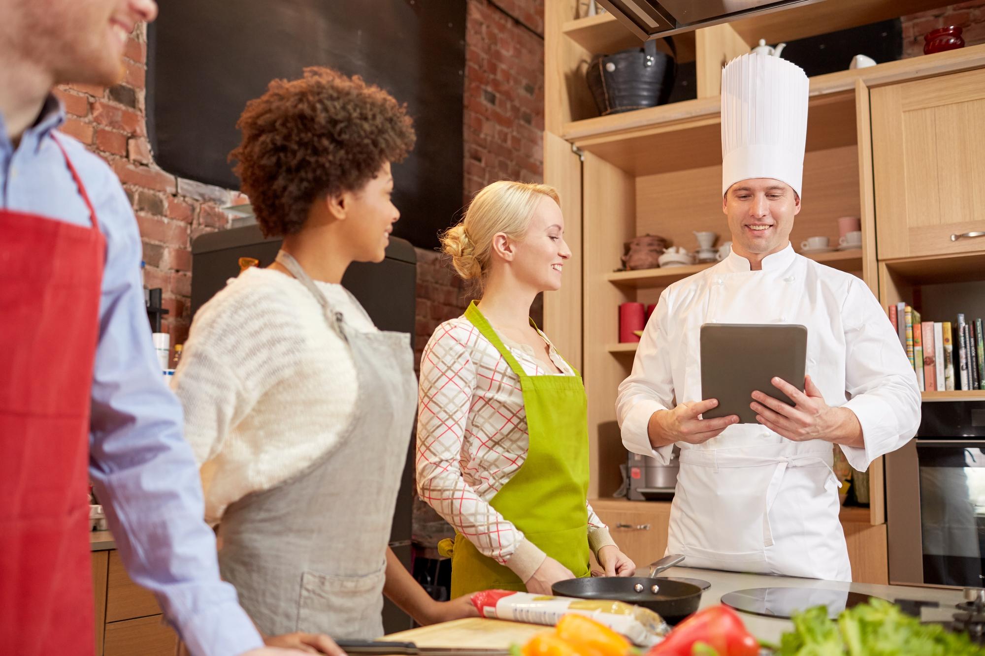 Small group in a modern kitchen studio learning plating